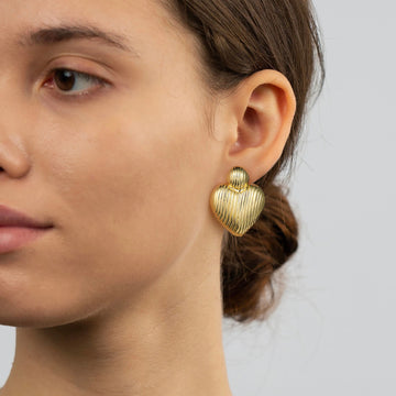 Gold-colored, a pair of heart-shaped earrings, one large and one small