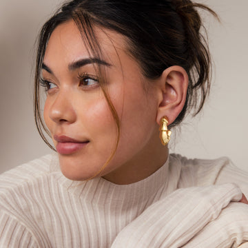 Golden-colored earrings with a sawtooth edge shape