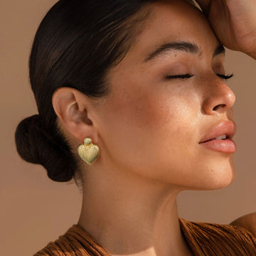 Golden-colored, bird-like heart-shaped earrings