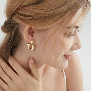Golden-colored, structured and shaped earrings