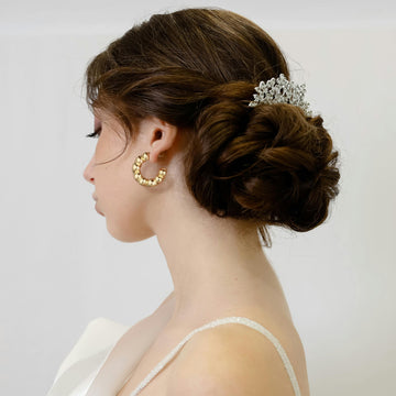 Golden, twisted C-shaped letter earrings