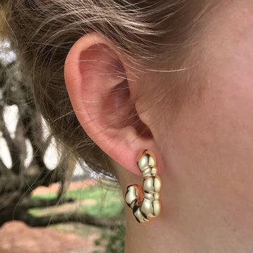 Golden-colored, large C-shaped thick earrings