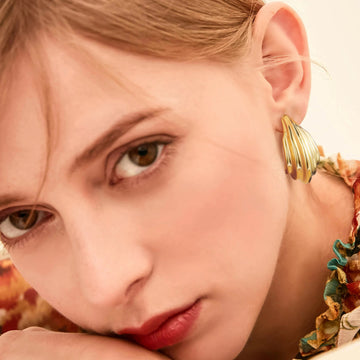 Golden, round and curved hook-shaped earrings