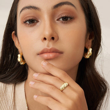 Golden earrings with a scale-like pattern