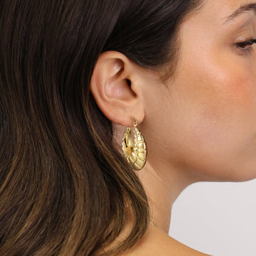 Golden, trapezoidal patterned crescent shaped earrings