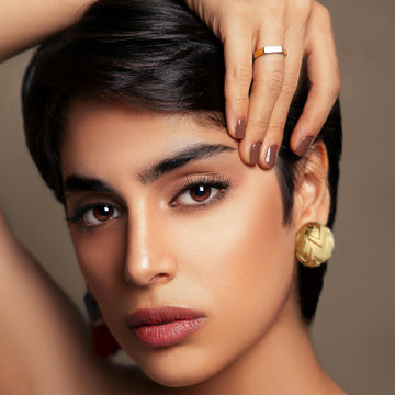 Golden, round earrings with concave and convex texture