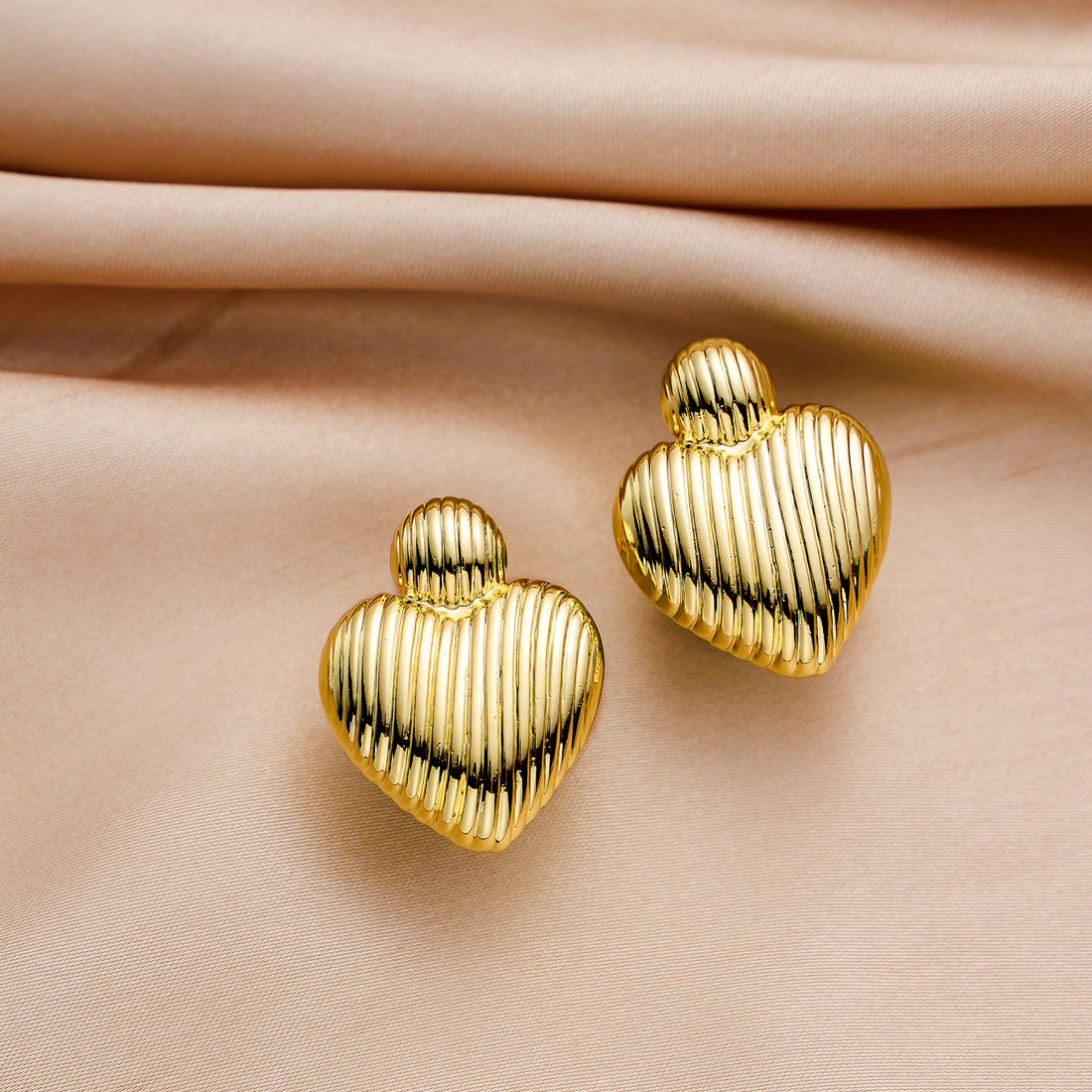 Golden-colored, bird-like heart-shaped earrings