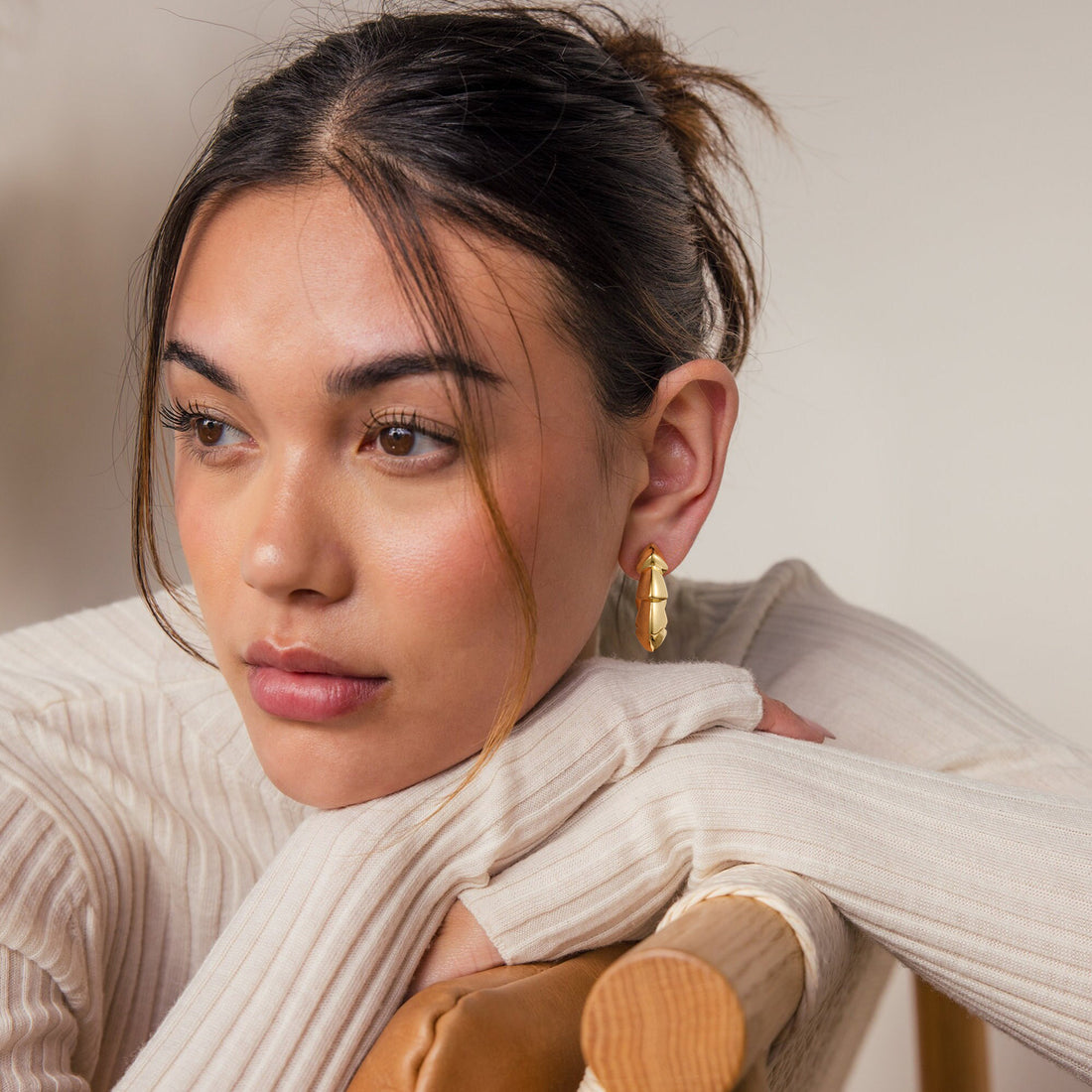 Golden-colored earrings with a sawtooth edge shape
