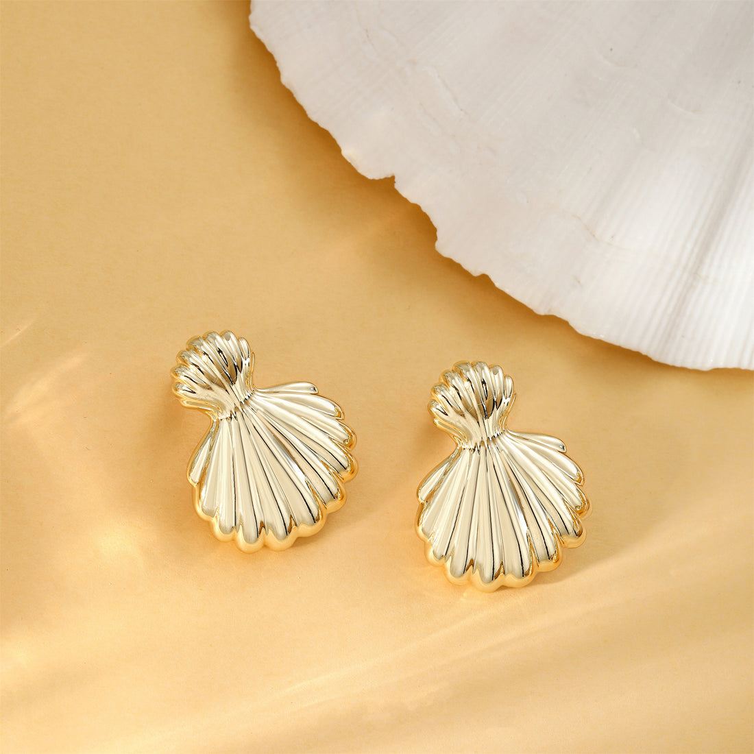 Golden-colored, large and small shell earrings