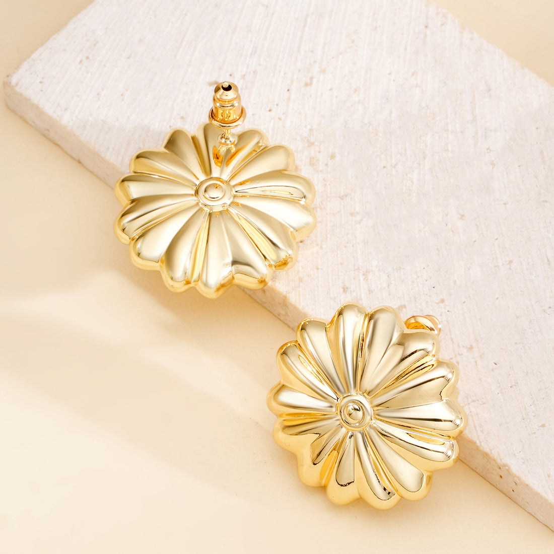 Golden-colored daisy-shaped earrings