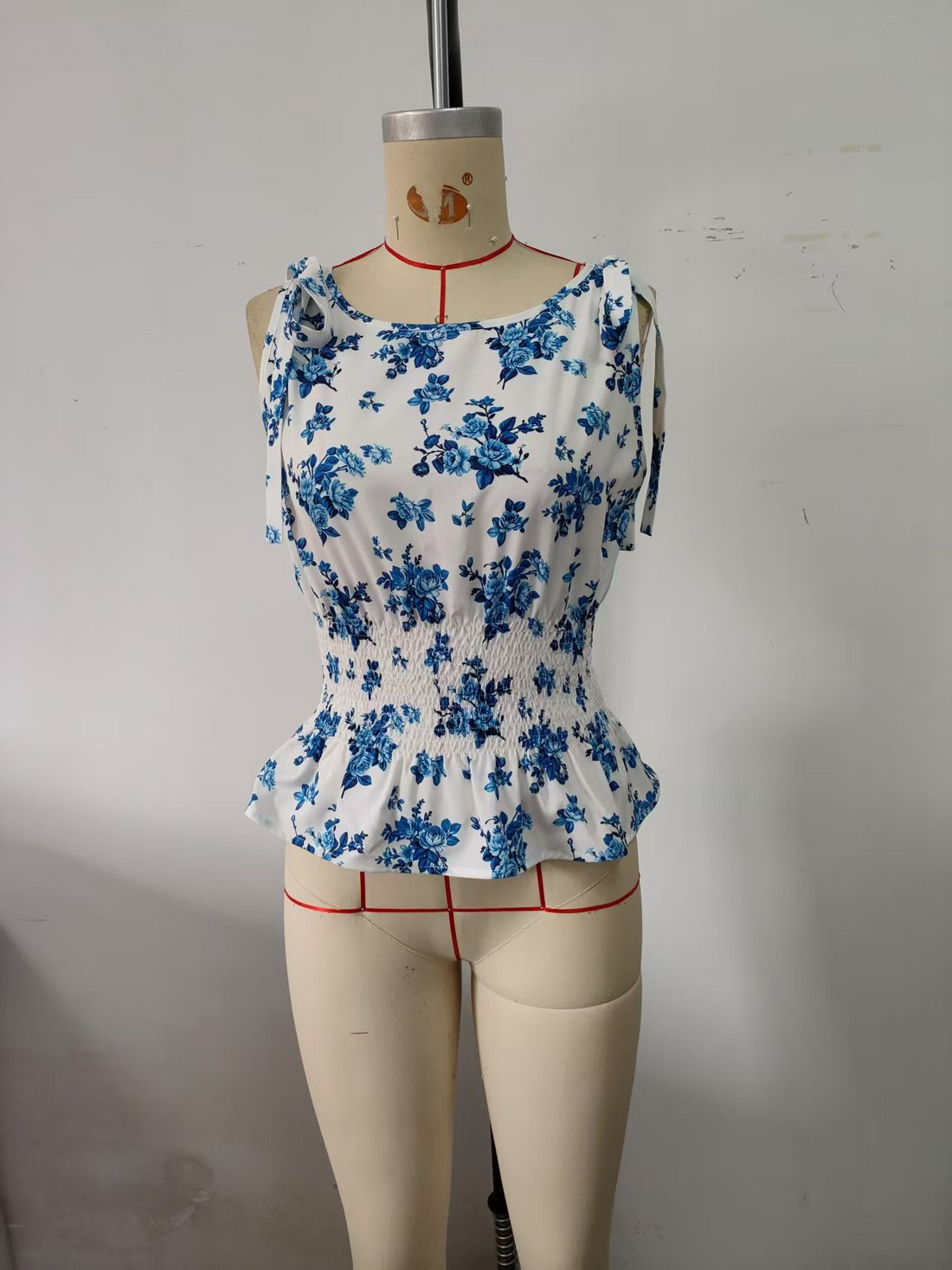Blue, women's top, sleeveless, blue floral print, elastic waistband, ruffled hem