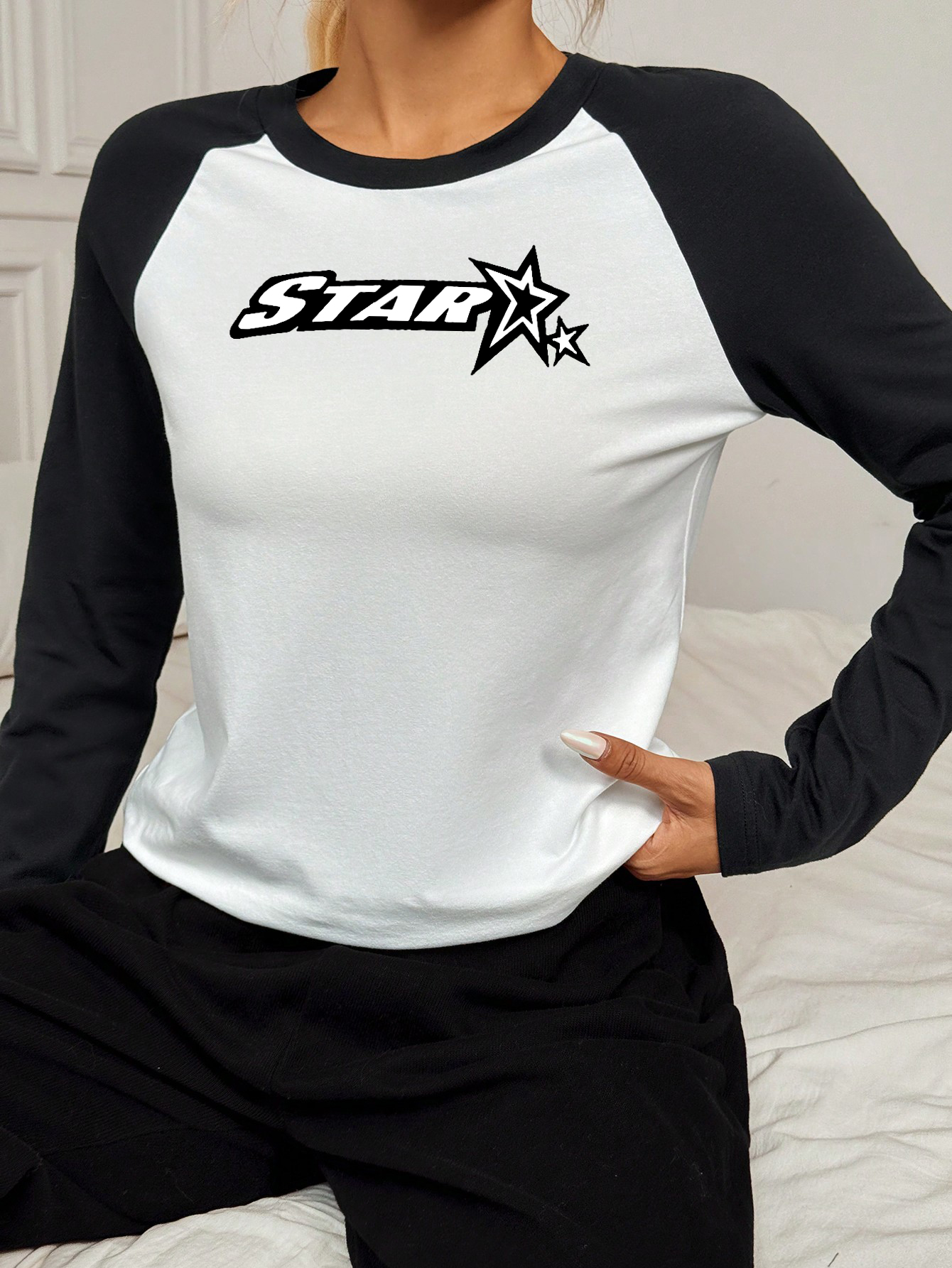 Women's long sleeved T-shirt with white body and black sleeves, featuring STAR and two star patterns on the chest