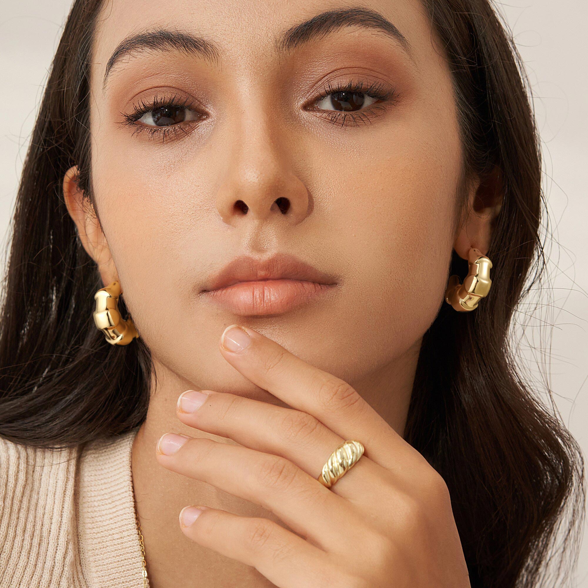 Golden earrings with a scale-like pattern