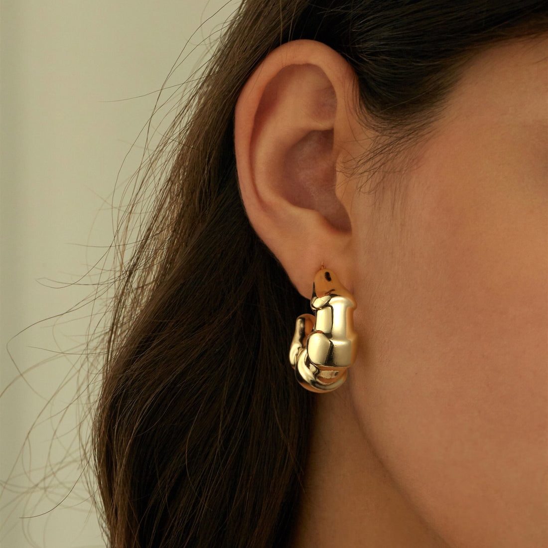 Golden earrings with a scale-like pattern
