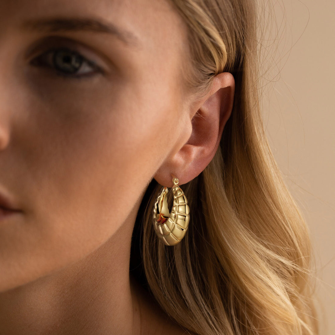 Golden, trapezoidal patterned crescent shaped earrings