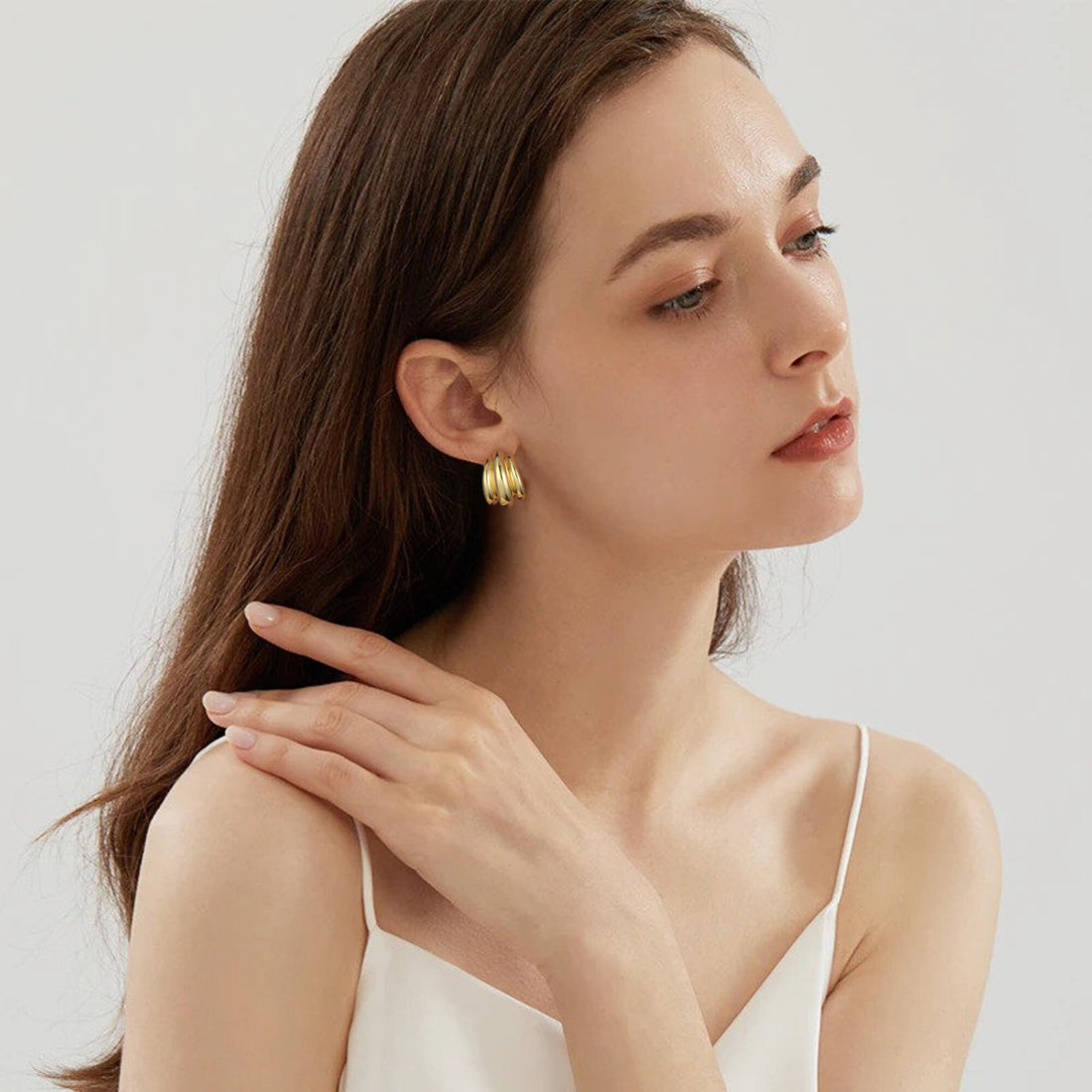 Golden-colored earrings with a pumpkin-shaped design